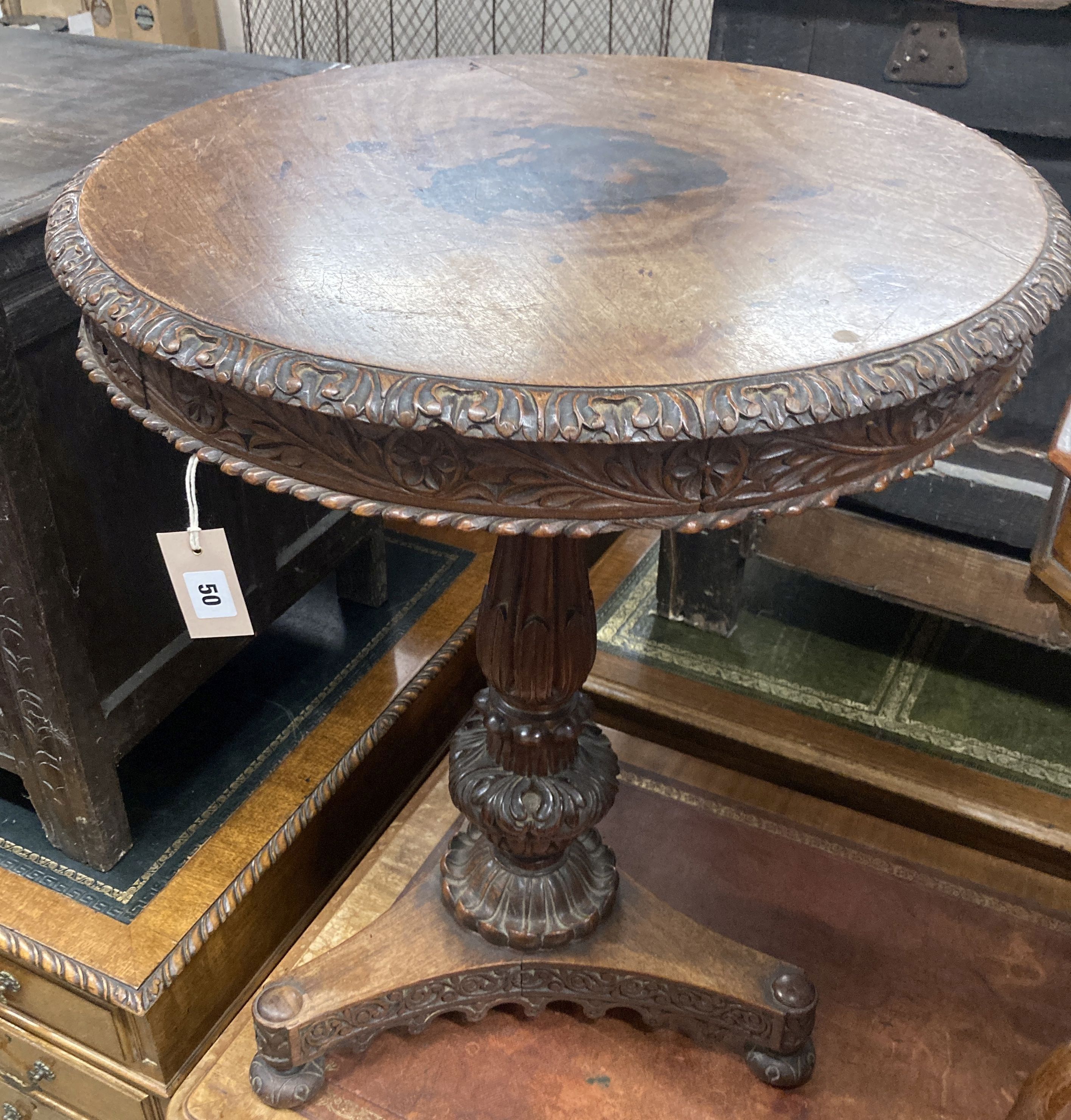 A 19th century Anglo / Indian carved padouk circular tilt top table, 60cm diameter, height 74cm